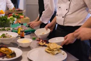 team cooks and chefs preparing meal photo