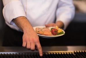 chef hands cooking grilled salmon fish photo