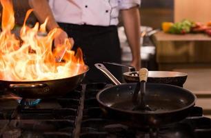 Chef doing flambe on food photo