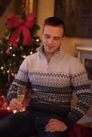 Happy young man with a glass of champagne photo