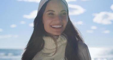 Girl In Autumn Clothes Smiling on beach photo