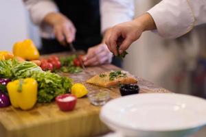 Chef hands preparing marinated Salmon fish photo