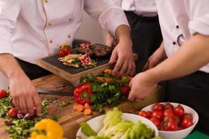 team cooks and chefs preparing meal photo