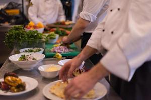 team cooks and chefs preparing meal photo