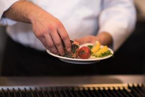 chef hands cooking grilled salmon fish photo