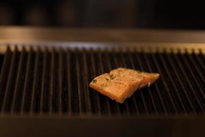 Salmon fillets cooking on grill photo