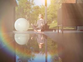 young woman doing morning yoga exercises photo