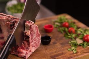 chef cutting big piece of beef photo