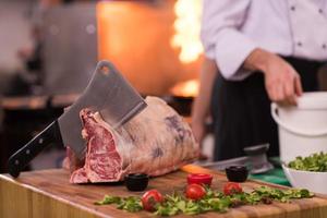 chef cutting big piece of beef photo