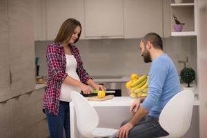 couple cooking food fruit lemon juice at kitchen photo