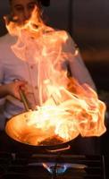 Chef doing flambe on food photo