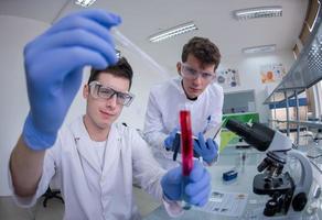 Group of young medical students doing research photo
