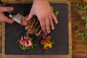 top view of Chef hands preparing beef steak photo