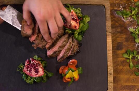 top view of Chef hands preparing beef steak photo