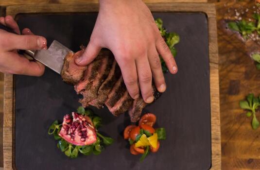 top view of Chef hands preparing beef steak photo