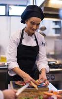 female Chef preparing beef steak photo