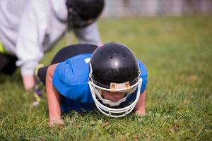 american football player doing push ups photo