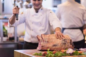 chef cutting big piece of beef photo