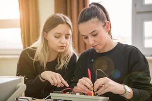 students doing practice in the electronic classroom photo