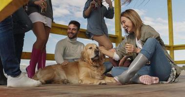 Group of friends having fun on autumn day at beach photo