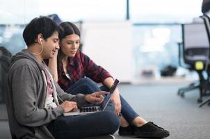 software developers couple working on the floor photo