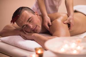 young man having a back massage photo