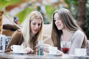 cute smiling women drinking a coffee photo