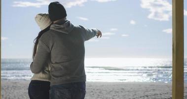 Couple having fun on beautiful autumn day at beach photo