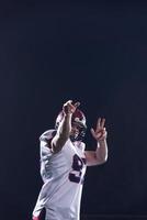 american football player throwing rugby ball photo