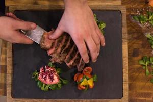 top view of Chef hands preparing beef steak photo
