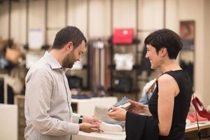 couple chooses shoes At Shoe Store photo