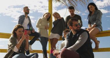 grupo de amigos divirtiéndose el día de otoño en la playa foto