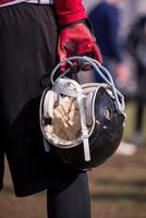 American football player holding helmet photo