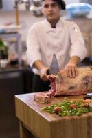 chef cutting big piece of beef photo