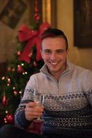 Happy young man with a glass of champagne photo