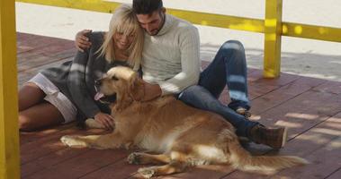 Couple with dog enjoying time on beach photo