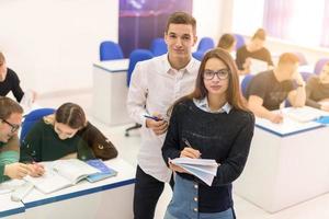 young students writing notes photo