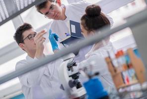 Group of young medical students doing research photo