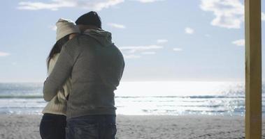 Couple having fun on beautiful autumn day at beach photo