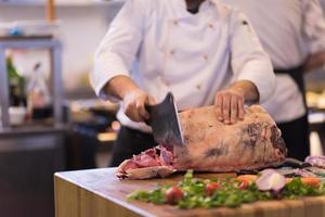 chef cutting big piece of beef photo