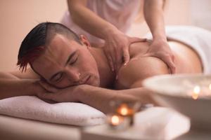 young man having a back massage photo