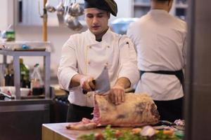 chef cutting big piece of beef photo