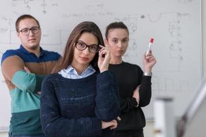 portrait of young students in front of chalkboard photo