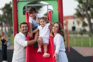 Senior couple in casual clothes with their children spending time in park a vacation together. Family time . Selective focus photo