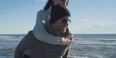 couple having fun at beach during autumn photo