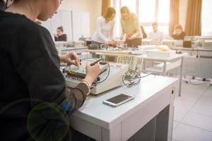 students doing practice in the electronic classroom photo