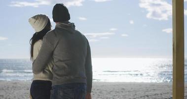 Couple having fun on beautiful autumn day at beach photo