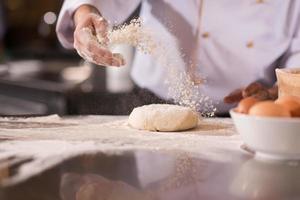 chef hands preparing dough for pizza photo