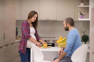 couple cooking food fruit lemon juice at kitchen photo