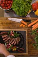 top view of Chef finishing steak meat plate photo